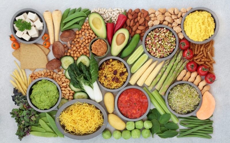 Vegan health food for a plant based diet with a large collection of food high in antioxidants, protein, minerals, fibre, anthocyanins, vitamins, lycopene, omega 3 smart carbs. Healthy eating concept.